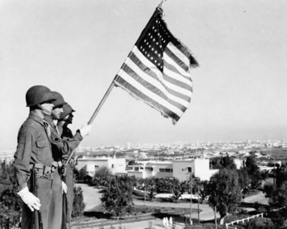 Des soldats américains brandissant le drapeau des Etats-Unis à Casablanca le 11 novembre 1942 lors de la Deuxième Guerre mondiale. / DR